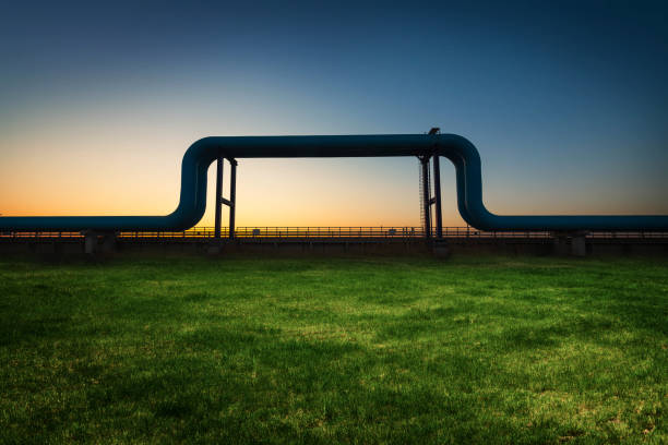 The oil pipeline on the grassland is in the sunset